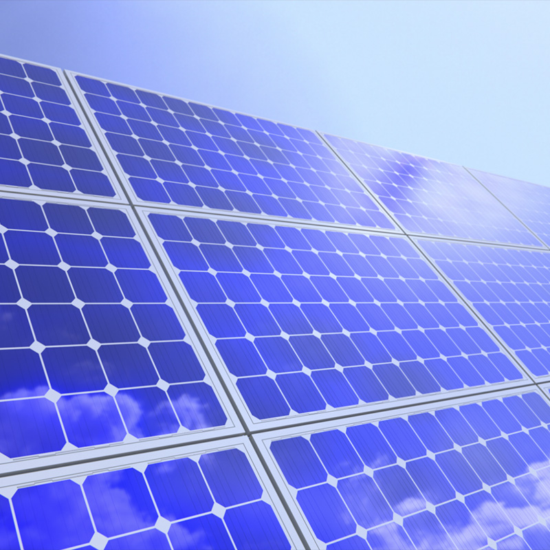 Close-up of blue solar panels under bright sunlight.