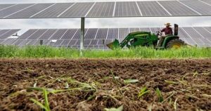 A woman with red hair working on a laptop in a bright, modern room.