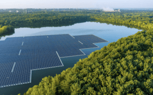 A woman with red hair working on a laptop in a bright, modern room.