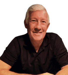A woman with red hair working on a laptop in a bright, modern room.