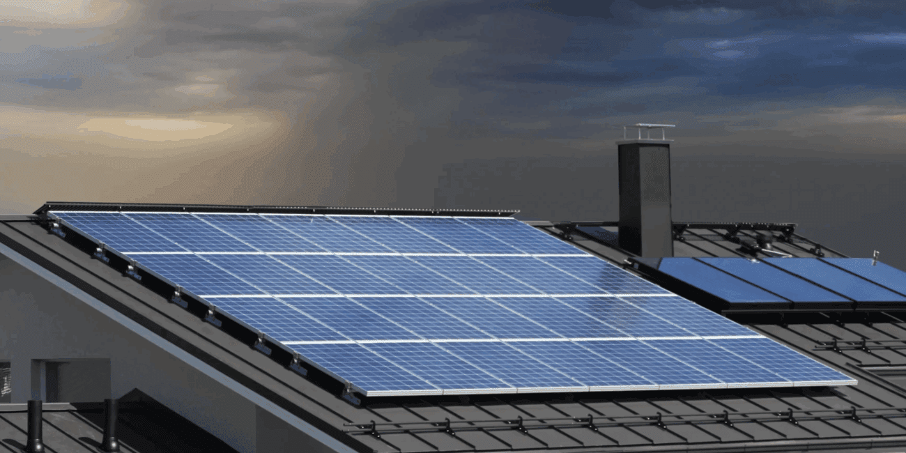 Solar panels installed on a rooftop under a cloudy sky.